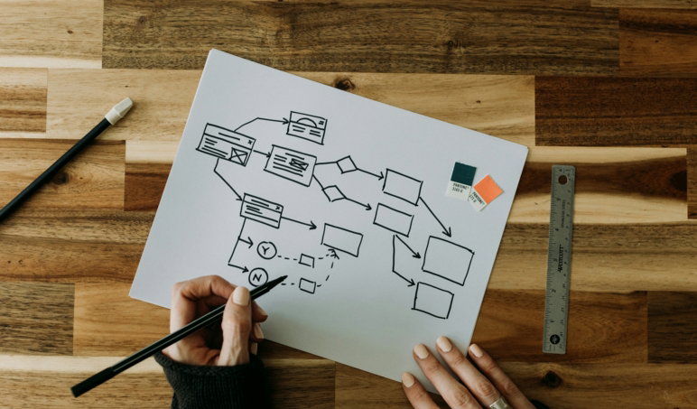 a-person-drawing-a-diagram-on-a-piece-of-paper.jpg a person drawing a diagram on a piece of paper